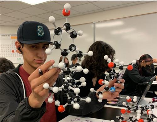  Student holding chemistry modeling kit